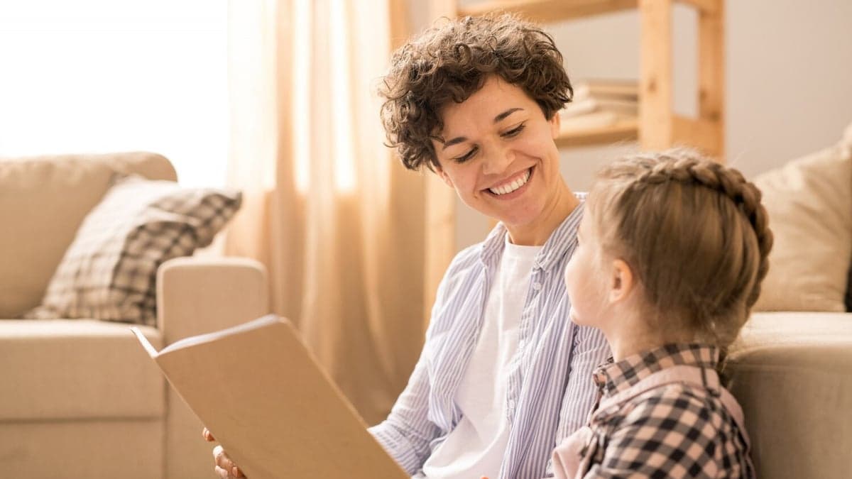 Parent and child talking about an open book